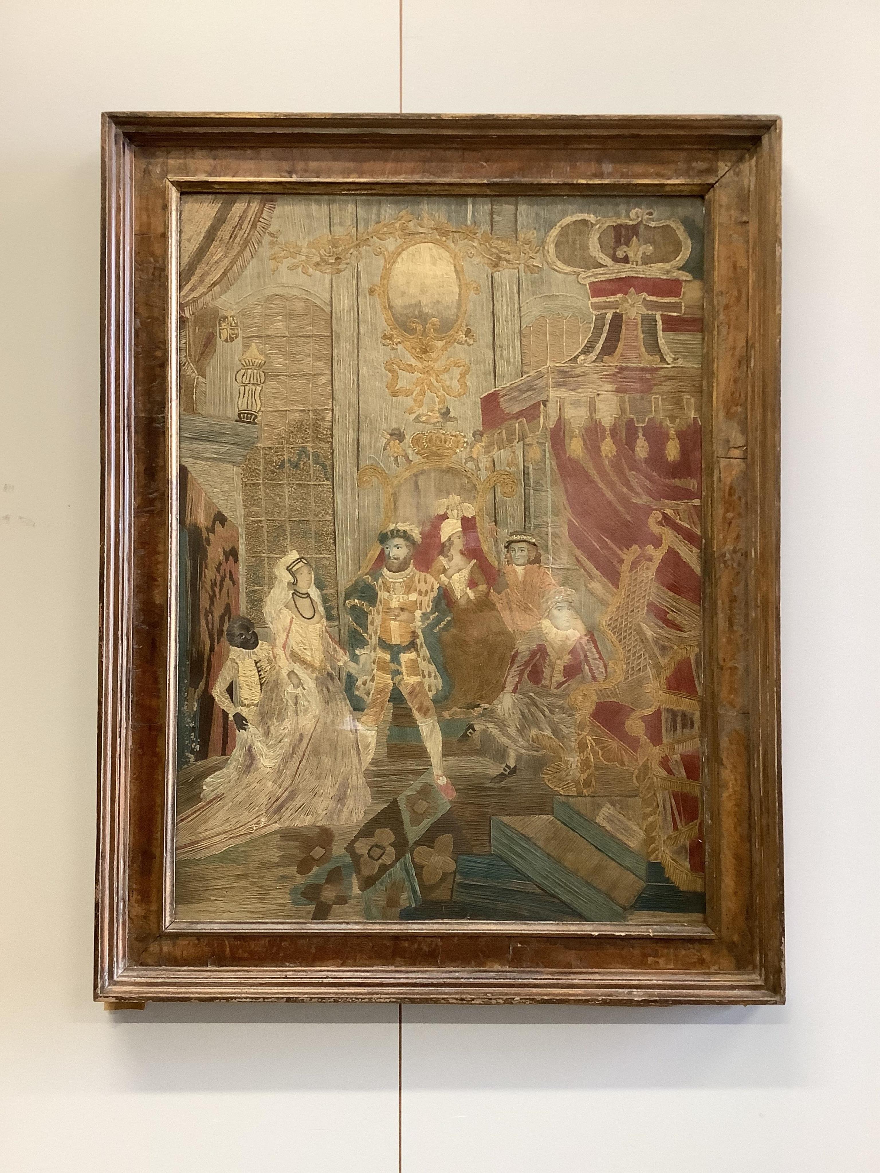 A large unusual Regency framed silk worked embroidery depicting Henry VIII in court with three courtiers and a blackamoor servant holding the dress of a young female courtier as she enters, worked mainly in long stem sti